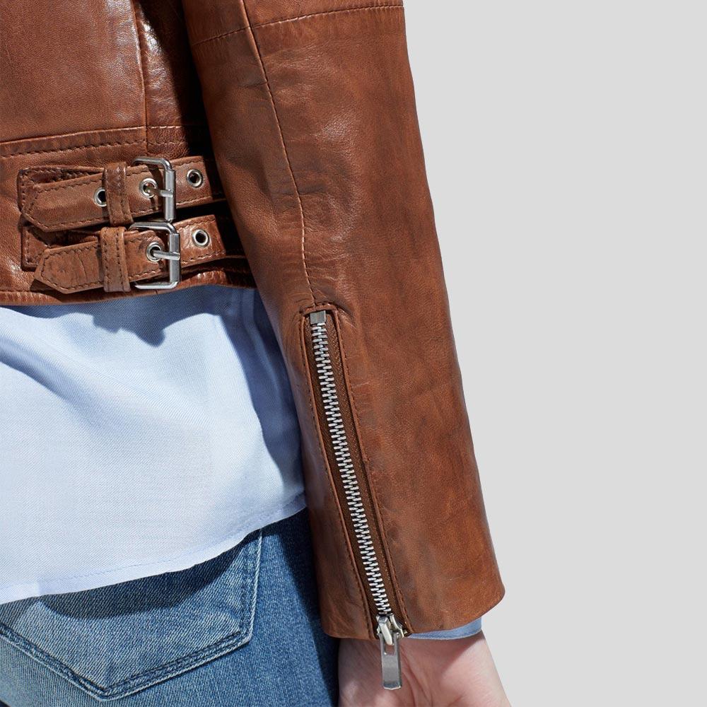Brown leather jacket with silver zippers and buckles on a light gray background
