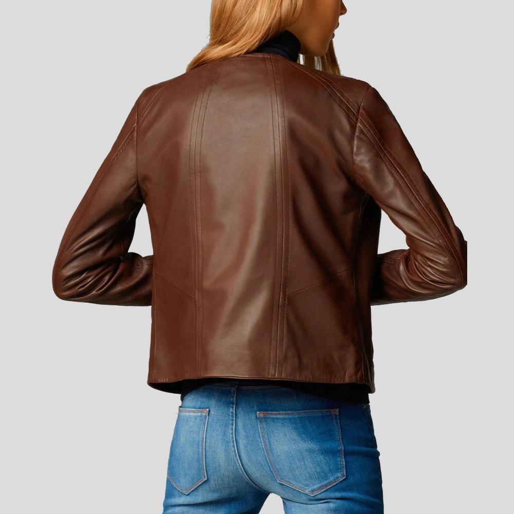 Person wearing a brown leather jacket and blue jeans on a light gray background