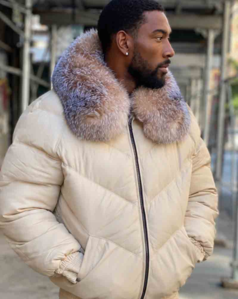 A man wearing a cream-colored goose jacket with a large, fluffy crystal fox-fur