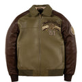 An olive green and dark brown leather jacket with a front zipper, ribbed collar, cuffs, and hem. The left chest features a circular patch with the text 'True To Our Roots' and '1978', and there is a circular patch on the right sleeve.