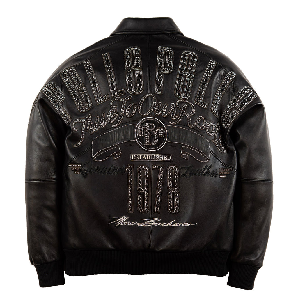 Black leather jacket shown from the back, featuring a large decorative graphic with the words 'PELLE PELLE', 'TRUE To Our Roots', 'Established 1978', and 'New Bachelors' embellished with rhinestone-like detailing, on a white background.