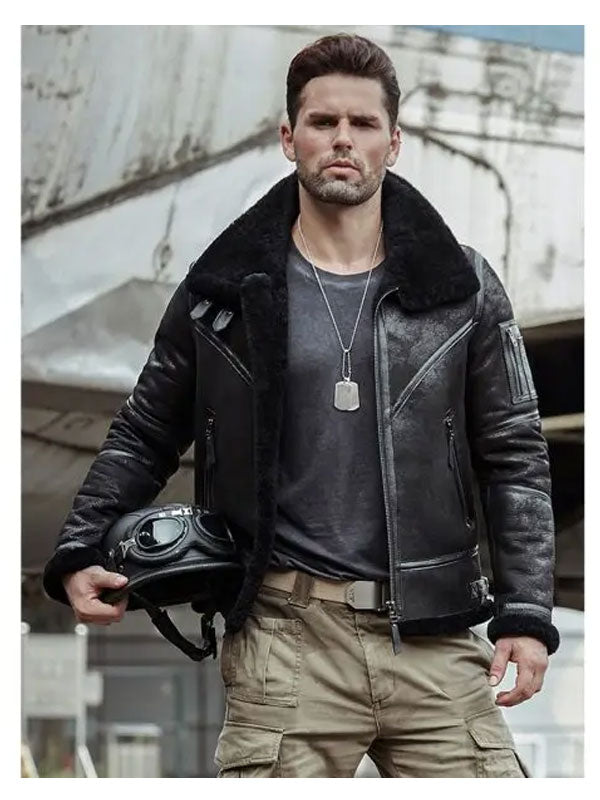 Man wearing a black leather jacket with a helmet, standing in an urban setting.