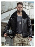 Man wearing a black leather jacket with a helmet, standing in an urban setting.