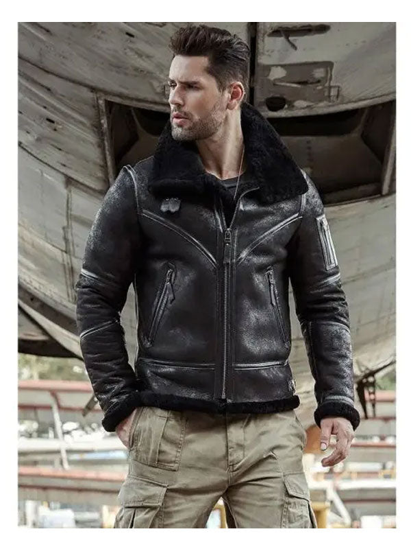 Man wearing a black leather jacket with fur collar in an industrial setting