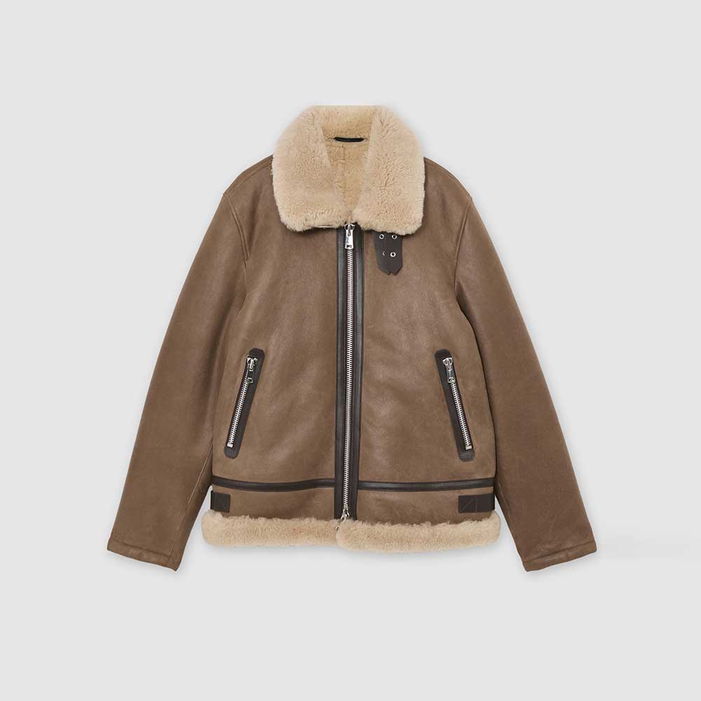 A brown shearling-lined aviator jacket with black zippers and trim, displayed flat against a light gray background.