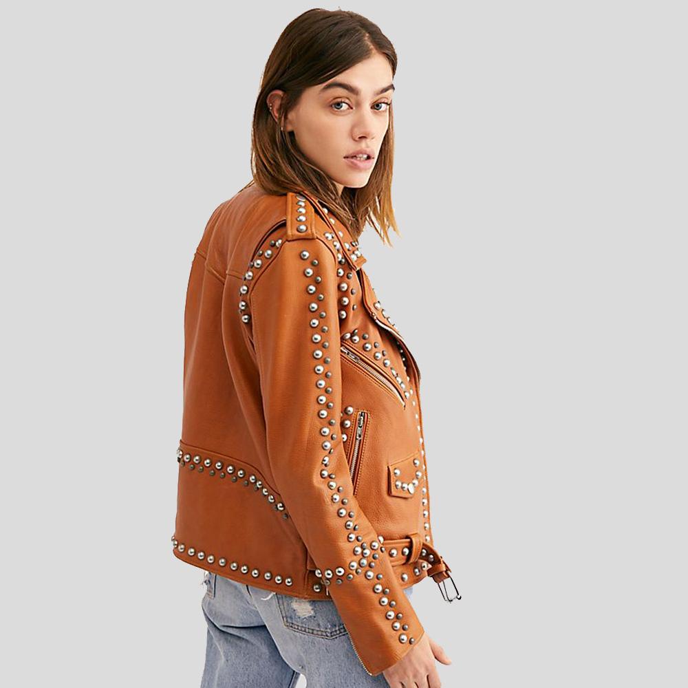 Woman wearing a brown leather jacket with studs on a gray background