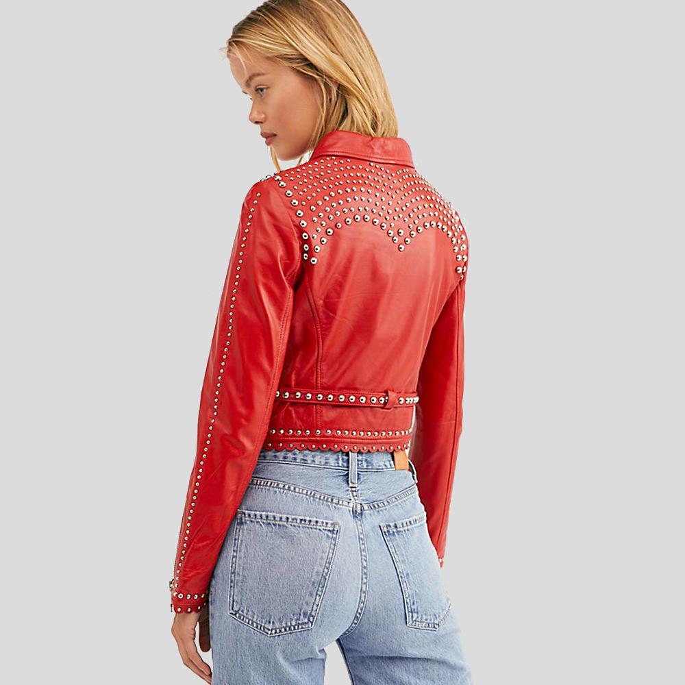 Person wearing a red studded jacket and blue jeans on a light gray background