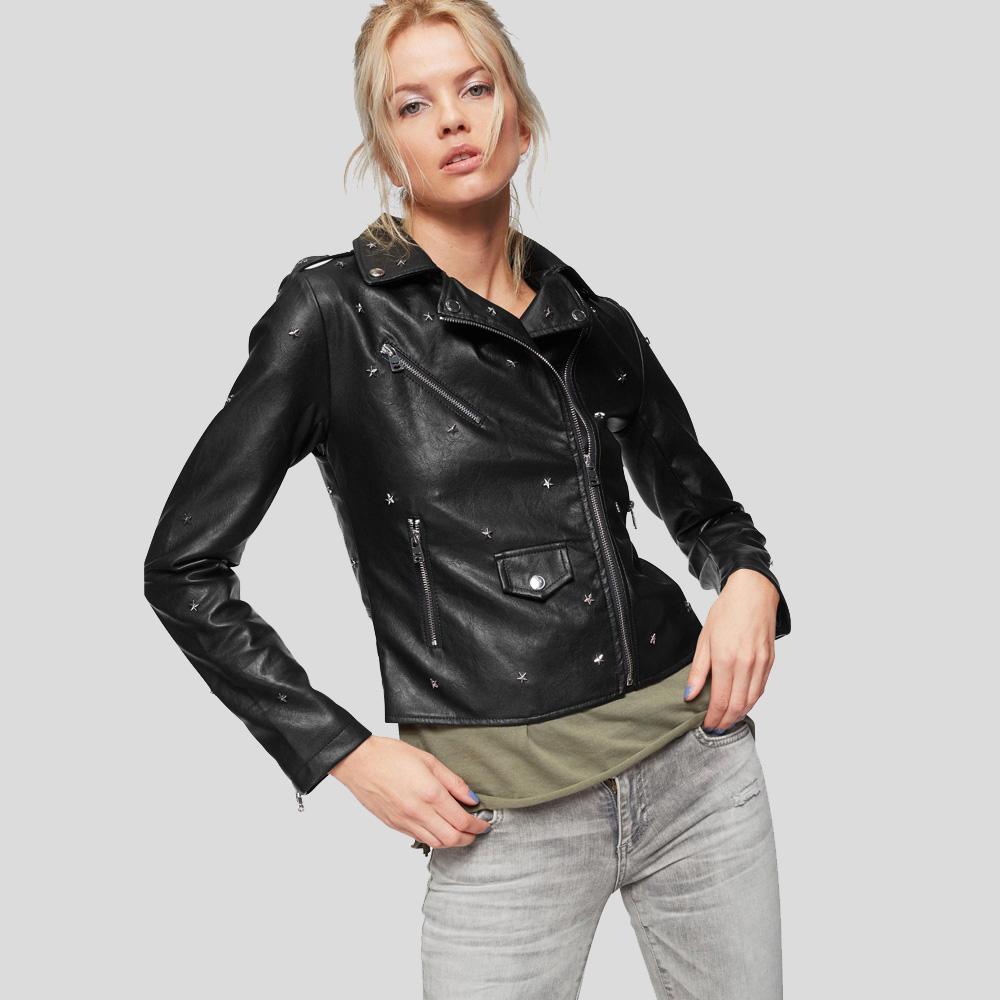 Woman wearing a black leather jacket on a gray background