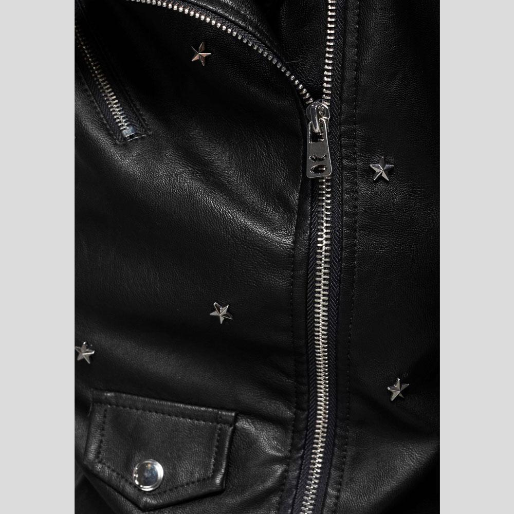 Close-up of a black leather jacket with star-shaped studs and zippers.