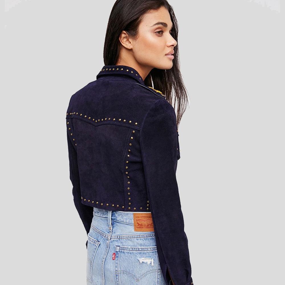 Woman wearing a dark blue studded jacket on a gray background