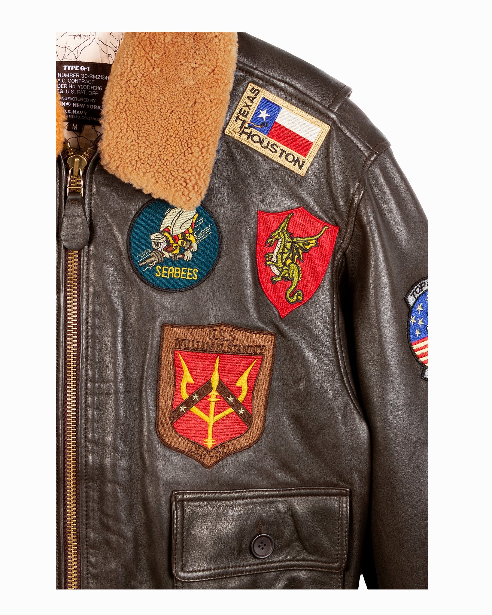 Close-up of a leather jacket with various patches including a Texas Houston patch.