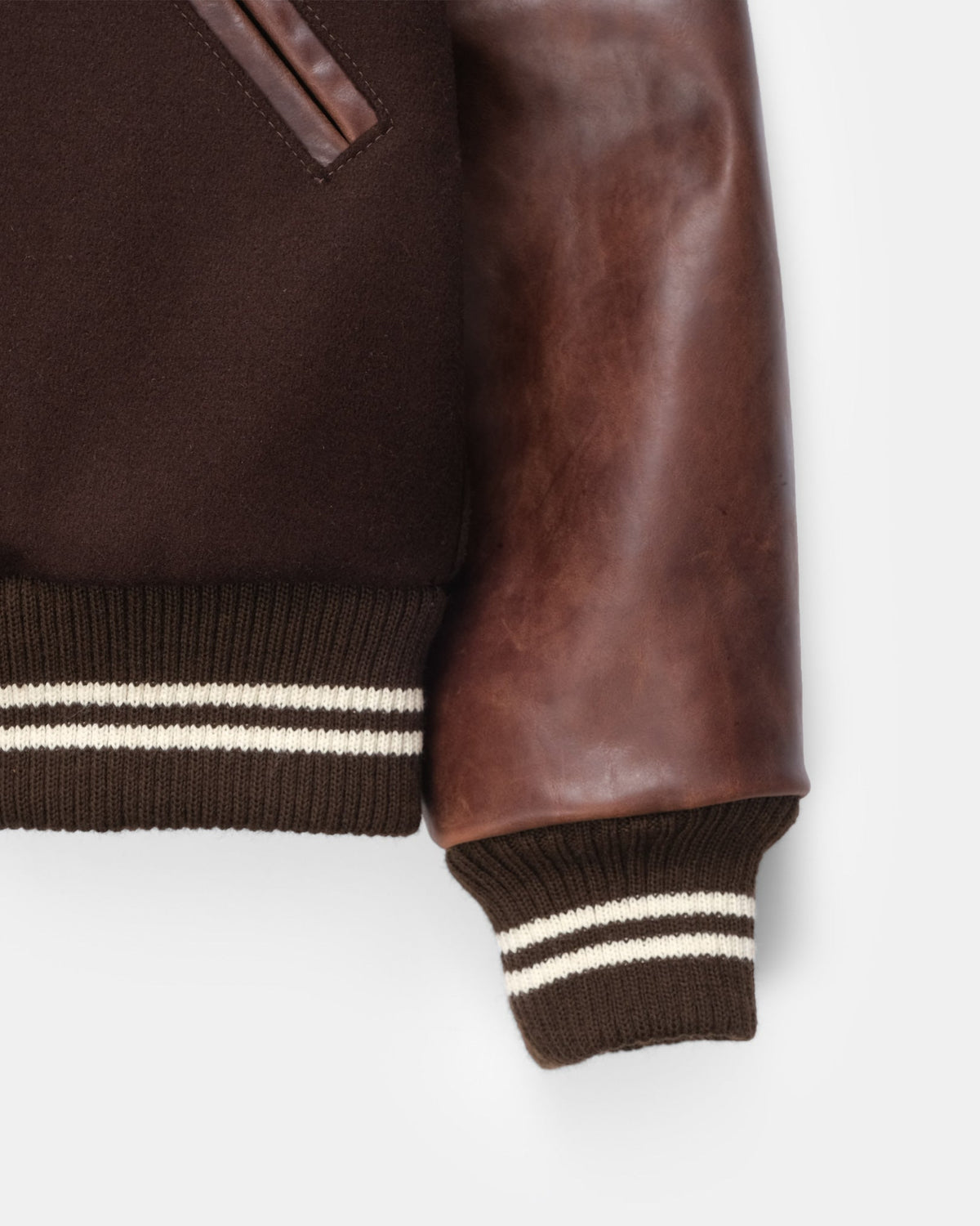 Brown leather jacket with white stripes on cuffs and hem against a white background