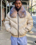 A man wearing an off-white goose country jacket with a large, crystal fox-fur collar, paired with light blue sweatpants, standing on an outdoor city sidewalk.