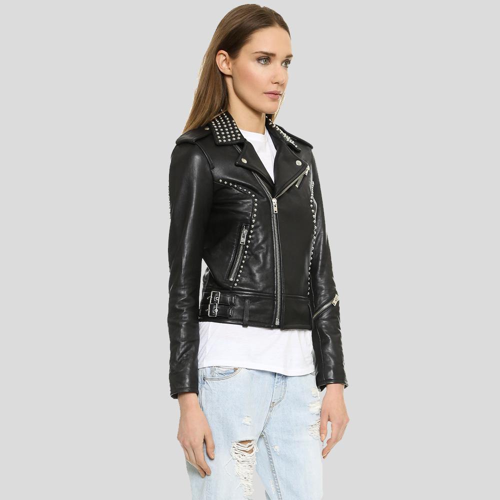 Woman wearing a black leather jacket with studs on a gray background