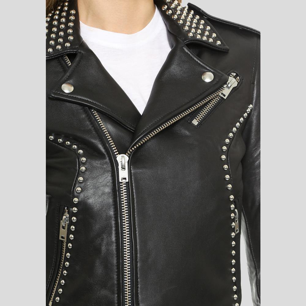 Black leather jacket with silver studs and zippers on a light gray background