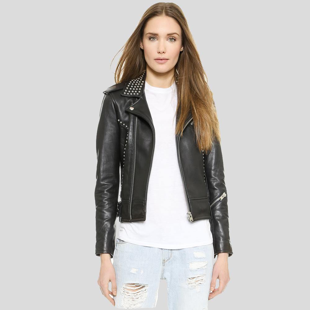 Woman wearing a black leather jacket with studs on a gray background