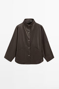 A dark brown leather jacket with a high stand collar, button-up front, and front flap pockets, displayed on a clean white background.