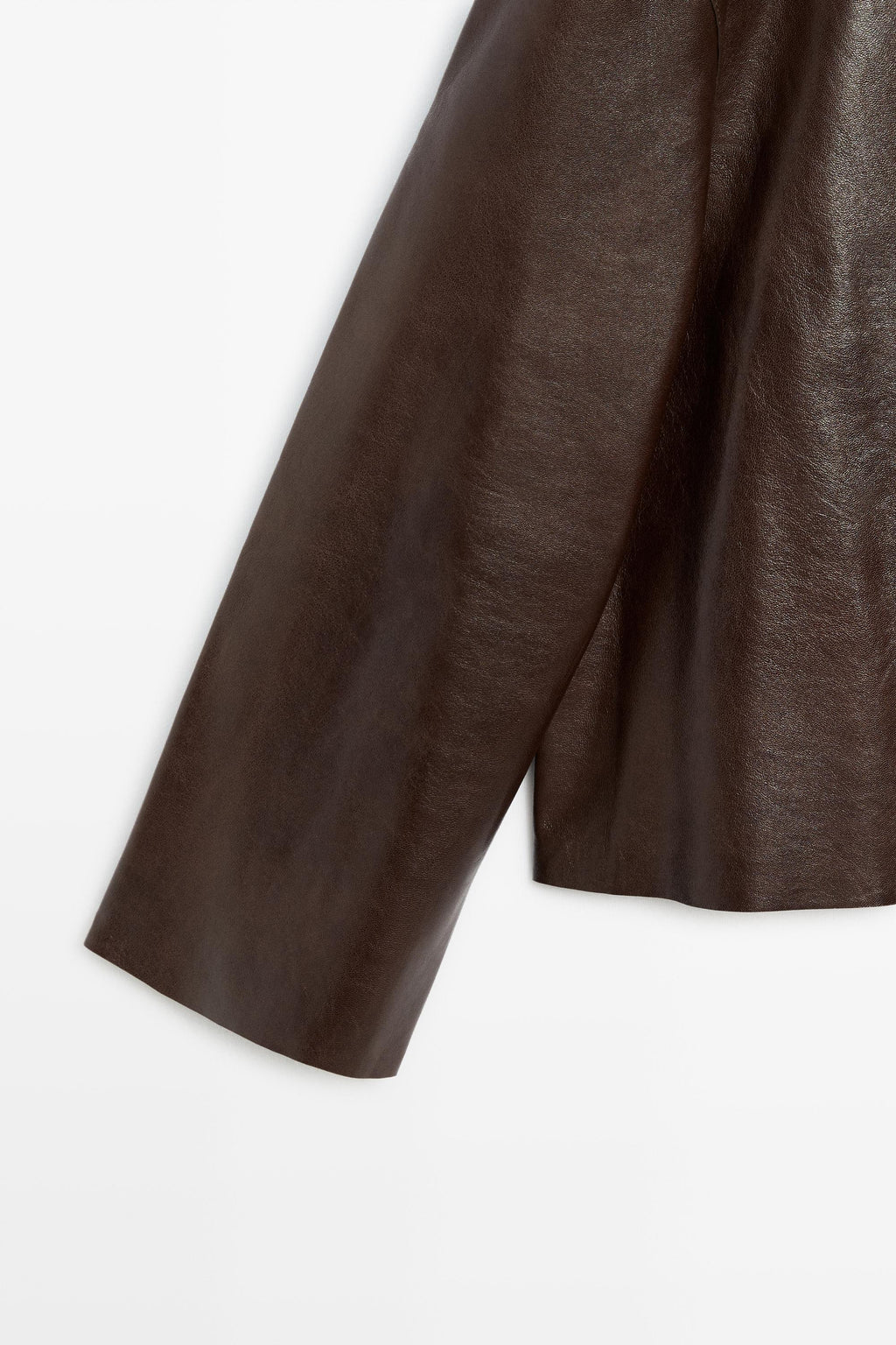Close-up of a dark brown leather or leather garment sleeve against a plain white background.