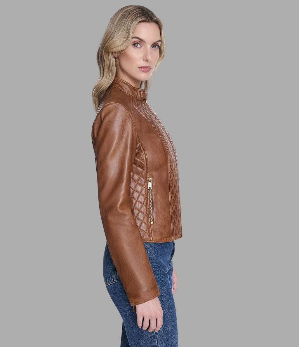 Woman wearing a brown leather jacket on a gray background