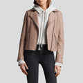 Person wearing a beige leather jacket over a white hoodie on a light gray background