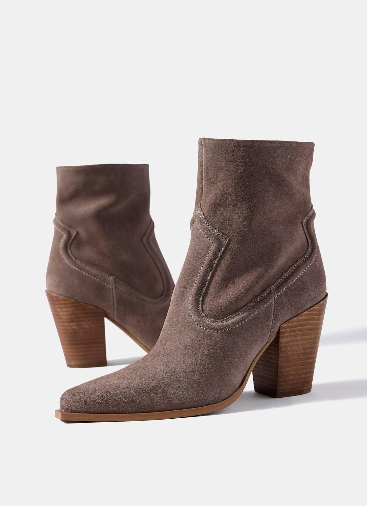 A pair of taupe-brown suede ankle boots with chunky stacked wooden block heels, shown on a clean white background.