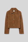 A cropped brown suede jacket with a collar, front buttons, and side pockets, displayed on a neutral gray background.